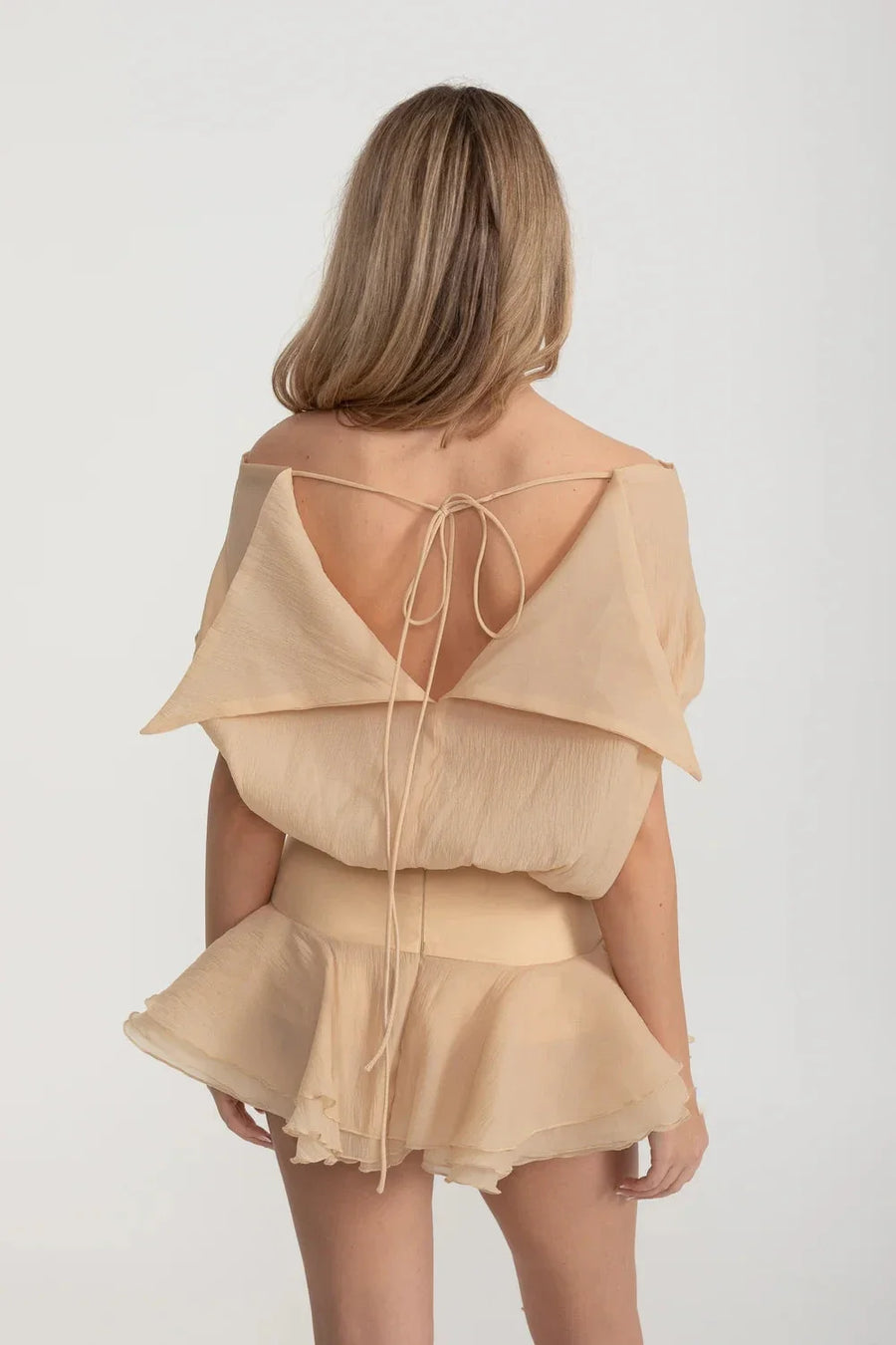 Elegant Mini Dress With Peplum Hem And Rosette Waist Embellishment - Beige